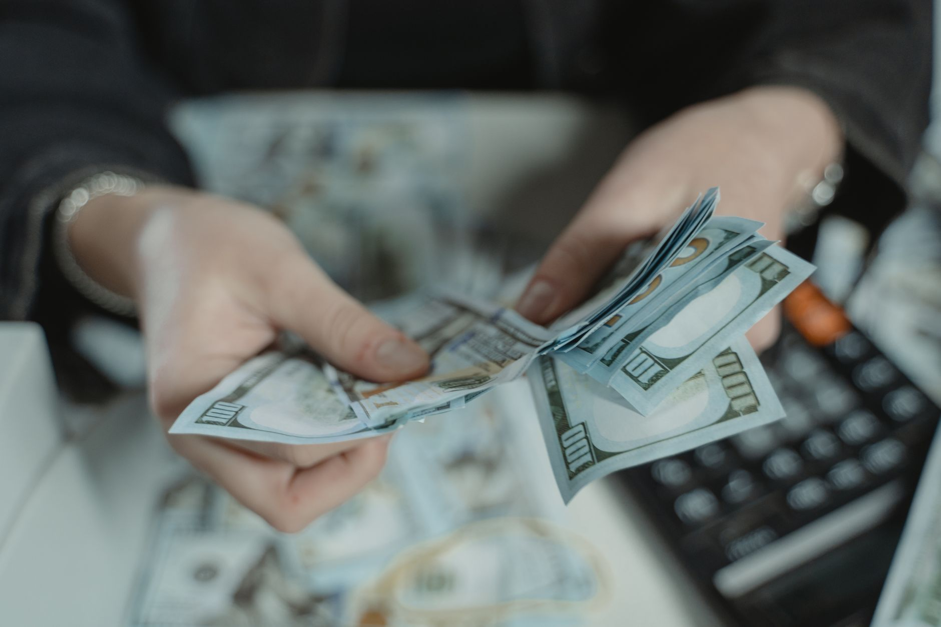 close up photo of a person counting bank notes